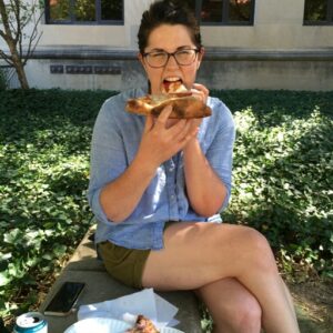 Heidi dramatically eating pizza.